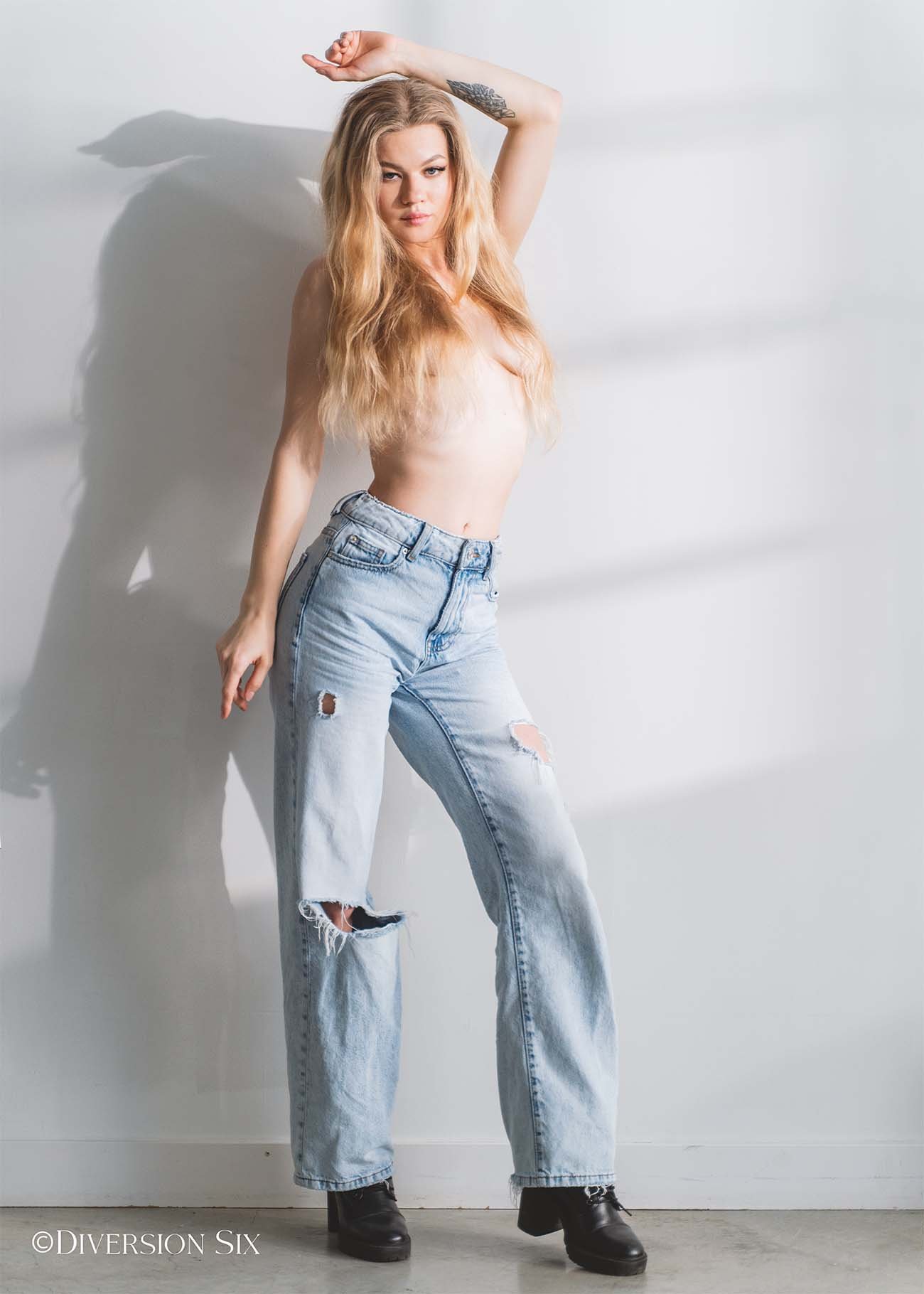 Hot topless blonde wearing blue jeans
