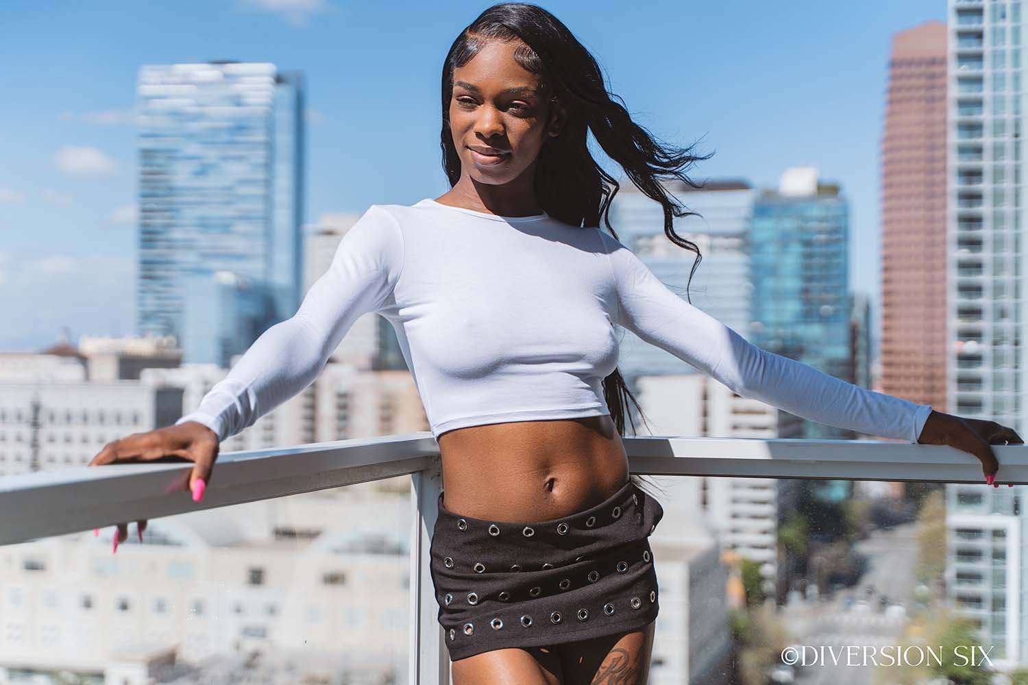 Model Ebony in a short sexy mini skirt and tight white crop top