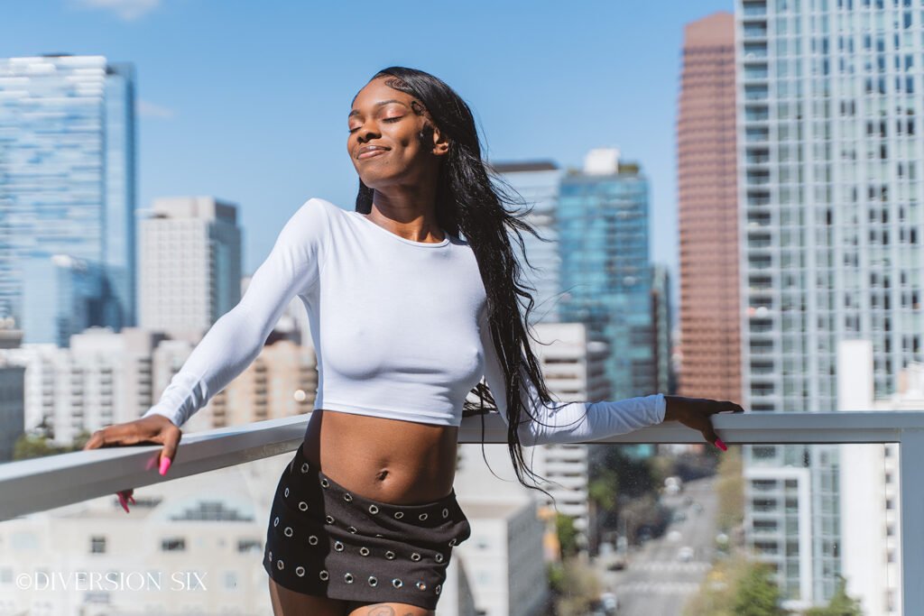 Ebony Doll standing wearing a sexy white crop top with perky nipples